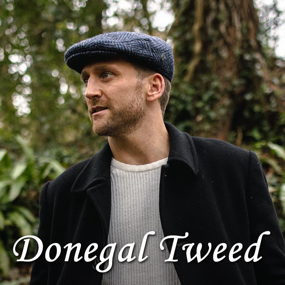 A man wearing a Donegal Tweed flat cap in the forest 